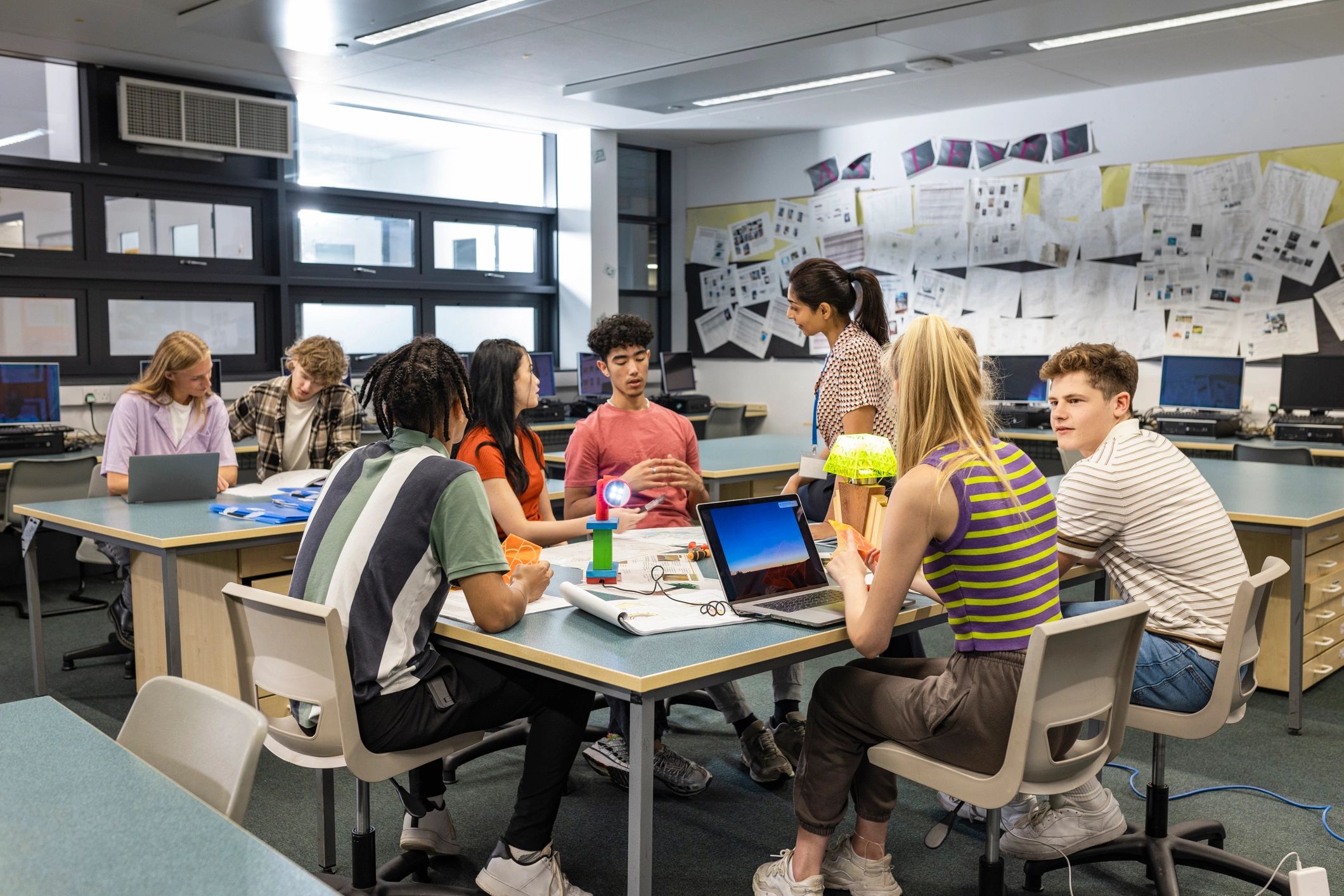 Students and teacher working together in a classroom