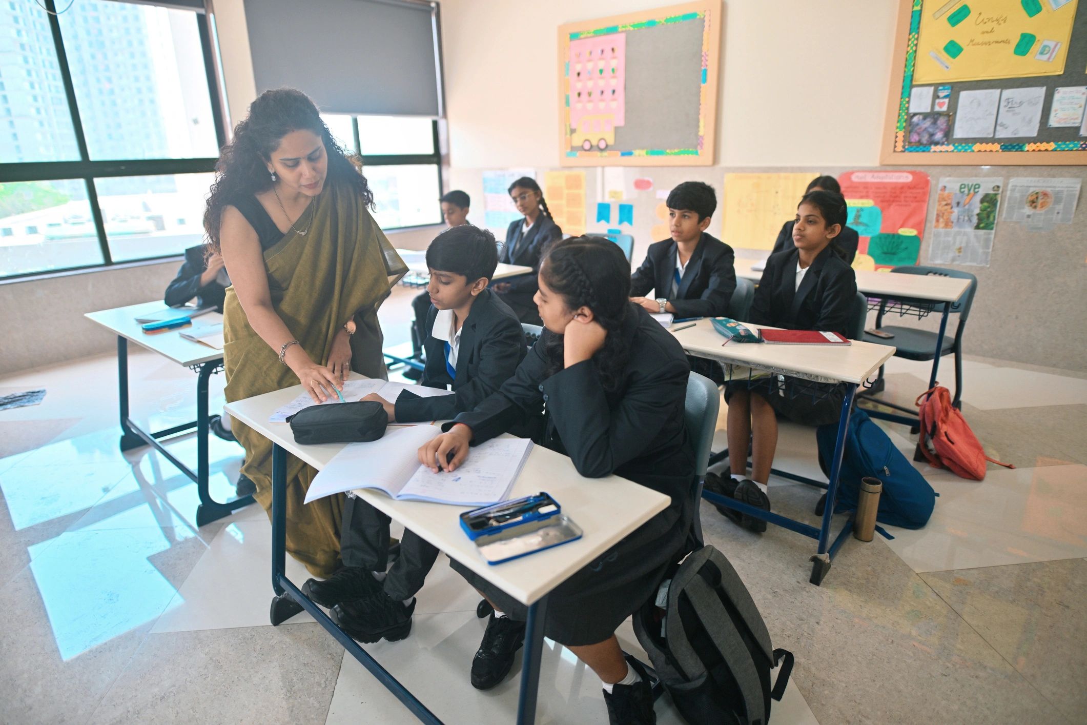 Teacher helping students during class
