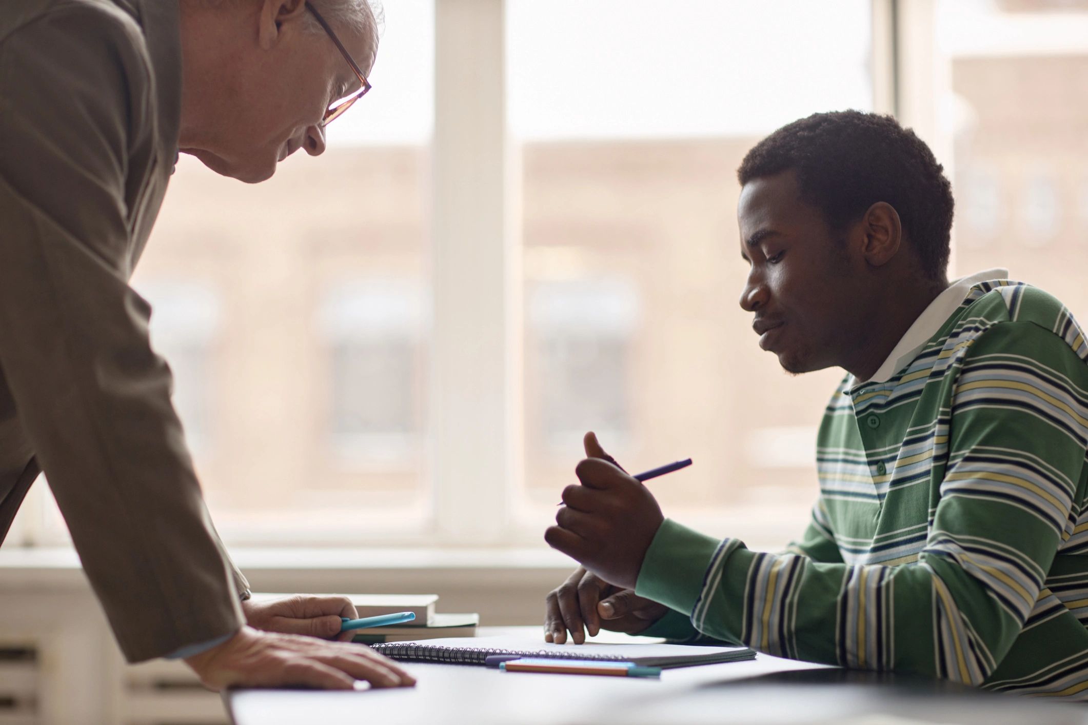 Teacher supporting a student during one-on-one tutoring